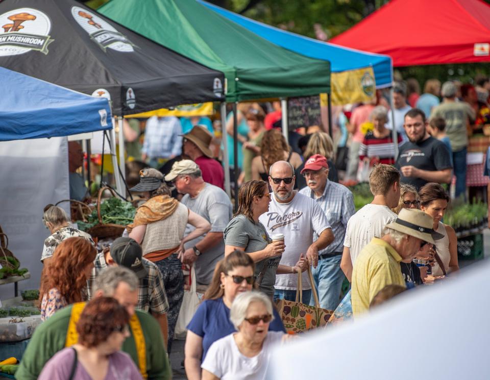 Hundreds of people shop at the Bloomington Community Farmer’s Market Aug. 17, 2019, at Showers Plaza.