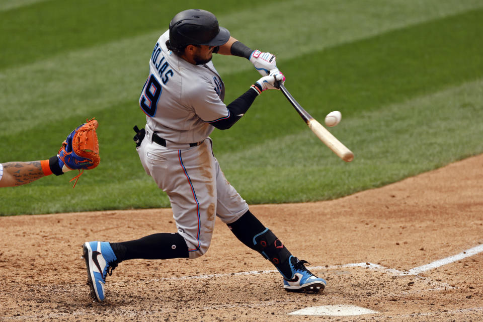 FILE - Miami Marlins' Miguel Rojas hits an RBI single during the sixth inning of a baseball game against the New York Mets in New York, in this Monday, Aug. 31, 2020, file photo. Rojas has been with the Marlins since 2015, longer than any other player. He's a perfect fit for a small-budget team because he's an overachiever, and thus a sound investment. (AP Photo/Adam Hunger, File)