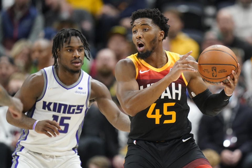 Sacramento Kings guard Davion Mitchell (15) guards Utah Jazz guard Donovan Mitchell (45) in the first half during an NBA basketball game Tuesday, Nov. 2, 2021, in Salt Lake City. (AP Photo/Rick Bowmer)