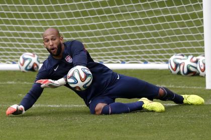 Tim Howard dives at a shot during a training session at the Sao Paulo FC training center on Wednesday. (AP)