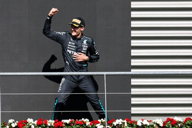 George Russell raises his fist after initially winning the Belgian Grand Prix