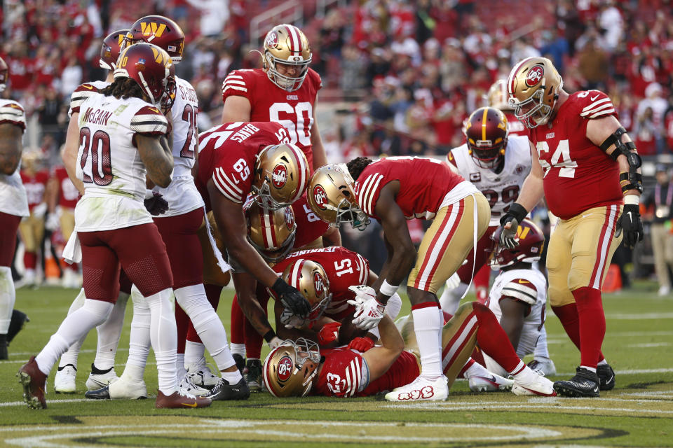 San Francisco 49ers running back Christian McCaffrey (23) celebrates his touchdown with teammates in the second half of an NFL football game against the Washington Commanders, Saturday, Dec. 24, 2022, in Santa Clara, Calif. (AP Photo/Jed Jacobsohn)