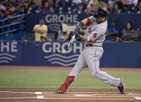 May 20, 2019; Toronto, Ontario, CAN; Boston Red Sox first baseman Mitch Moreland (18) hits a single during the first inning against the Toronto Blue Jays at Rogers Centre. Mandatory Credit: Nick Turchiaro-USA TODAY Sports