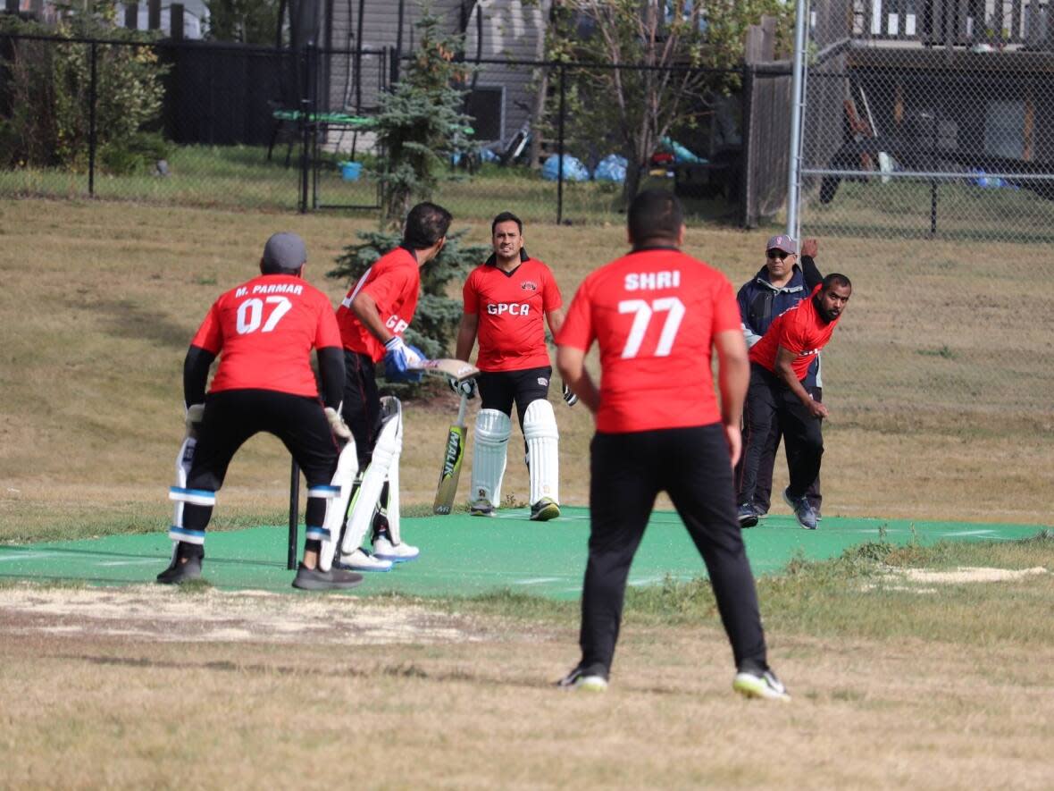 The Grande Prairie Cricket Association players using the turf pitch at Head and Salmond Family Park. The group is looking for more infrastructure to help grow the sport.  (Cricket In Grande Prairie Canada/Facebook - image credit)