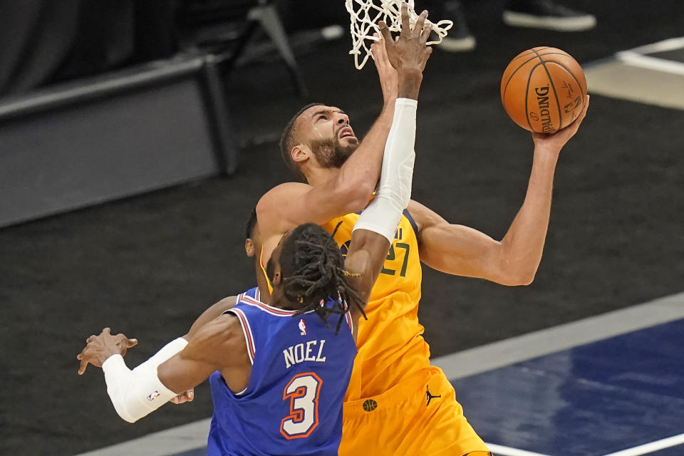 Utah Jazz center Rudy Gobert (27) lays the ball up as New York Knicks center Nerlens Noel (3) defends in the first half during an NBA basketball game Tuesday, Jan. 26, 2021, in Salt Lake City. (AP Photo/Rick Bowmer)