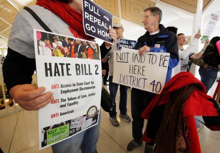 Opponents of North Carolina's HB2 law limiting bathroom access for transgender people protest in the gallery above the state's House of Representatives chamber as the legislature considers repealing the controversial law in Raleigh, North Carolina, U.S. on December 21, 2016. REUTERS/Jonathan Drake