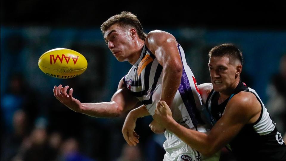 Jordon Sweet (right) makes a tackle for Port Adelaide.