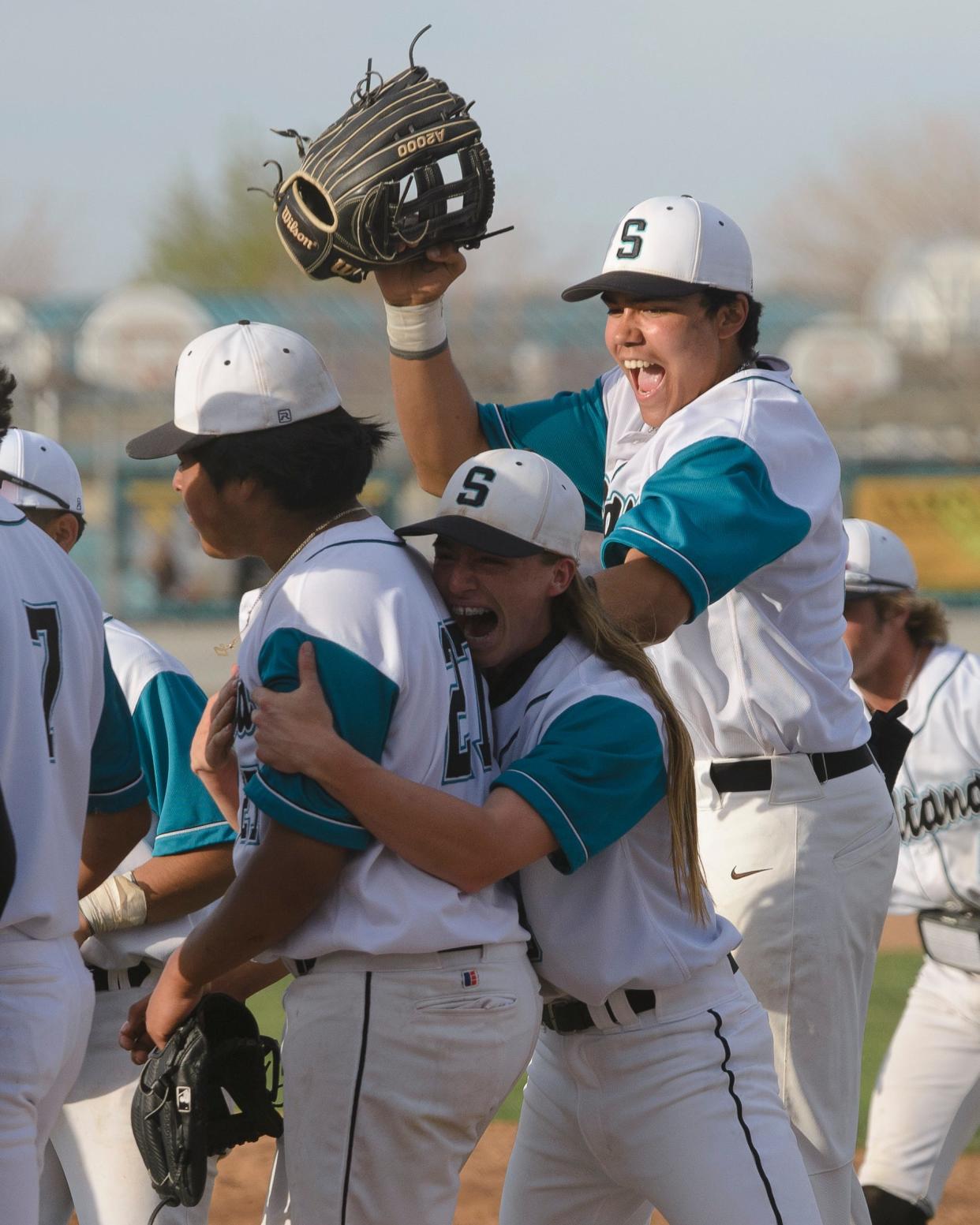 Sultana’s Oscar Lima, left, LJ Borrego, center, and Eric Ruiz celebrate after beating Oak Hills on Tuesday, April 11, 2023.