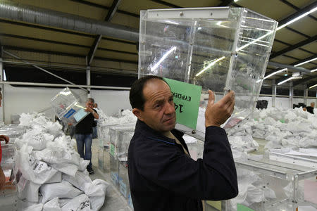Municipal workers carry ballot boxes to be used in the upcoming European and local elections in Thessaloniki, Greece, May 24, 2019. REUTERS/Alexandros Avramidis