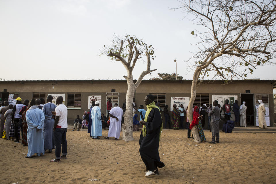 Senegalese voters line up to cast their ballot at a polling station in Dakar, Senegal Sunday Feb. 24, 2019. Voters are choosing whether to give President Macky Sall a second term in office as he faces four challengers.(AP Photo/Jane Hahn)