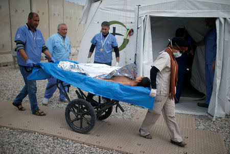 A wounded Iraqi arrives for treatment at the emergency field hospital run by the US Christian charity Samaritan's Purse, eastern Mosul, Iraq March 22, 2017. Picture taken March 22, 2017. REUTERS/Suhaib Salem