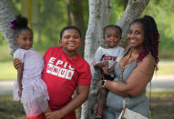 Tamika Davis, right, poses with three of her children, from left, Shanara, 3, Matthew, 11, and Lionel Jr., 2, at MLK Park in San Antonio, Thursday, May 30, 2024. Davis said friends and family watched her kids for most of her doctor visits during treatment last year for colon cancer. But she couldn't afford additional childcare, and she didn't know where to look for assistance. (AP Photo/Eric Gay)