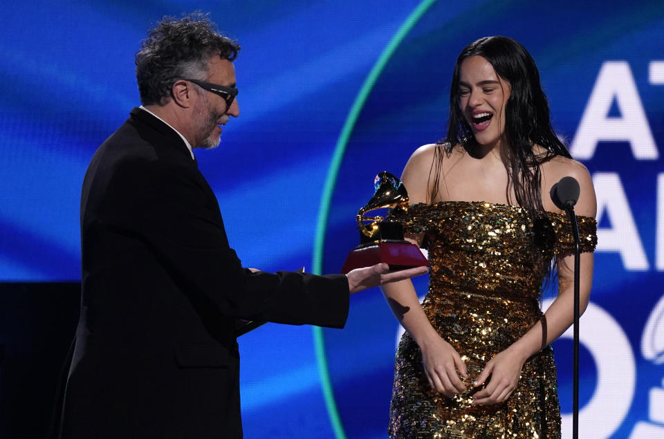 Fito Paez, left, presents Rosalia with the award for album of the year for "Motomami" at the 23rd annual Latin Grammy Awards at the Mandalay Bay Michelob Ultra Arena on Thursday, Nov. 17, 2022, in Las Vegas. (AP Photo/Chris Pizzello)