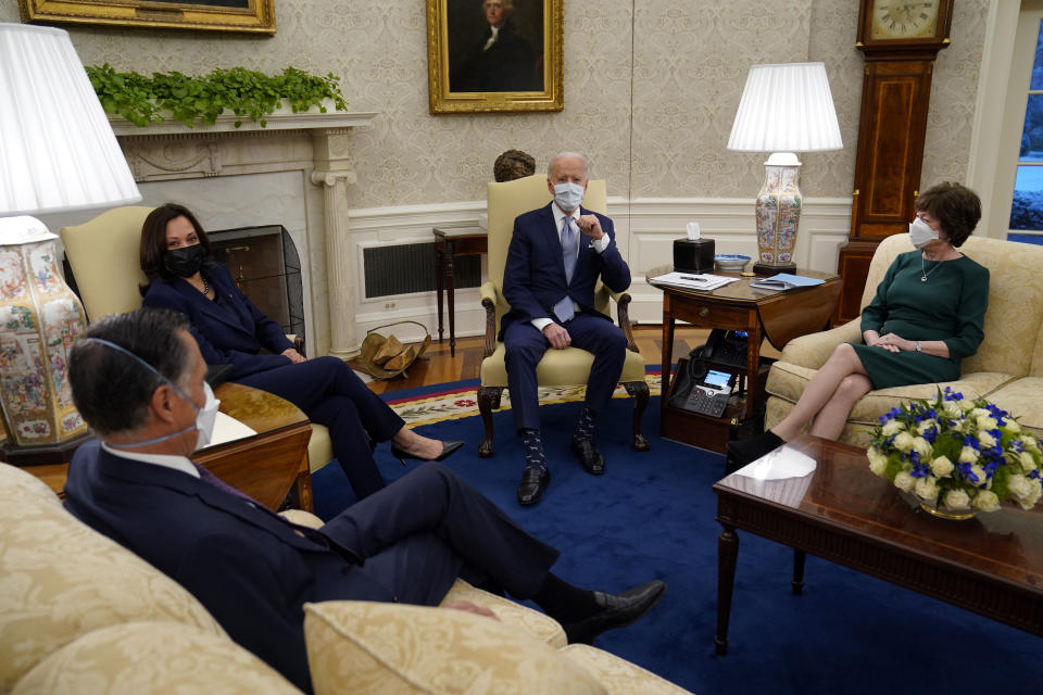 FILE - In this Feb. 1, 2021, file photo President Joe Biden and Vice President Kamala Harris meet with Sen. Mitt Romney, R-Utah, Sen. Susan Collins, R-Maine, and others to discuss a coronavirus relief package, in the Oval Office of the White House in Washington. (AP Photo/Evan Vucci, File)