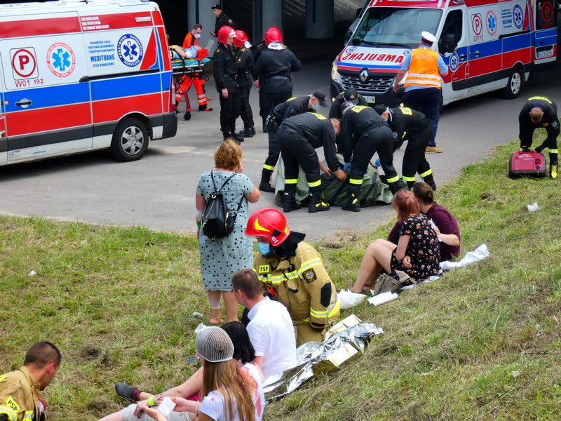 First responders attend to the scene of a public bus crash in Warsaw