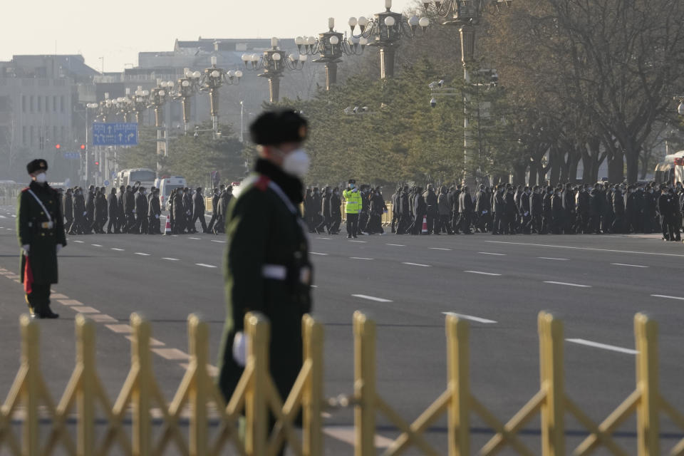 Attendees arrive for a memorial for the late former Chinese President Jiang Zemin outside the Great Hall of the People in Beijing, Tuesday, Dec. 6, 2022. A formal memorial service is held Tuesday at the Great Hall of the People, the seat of the ceremonial legislature in the center of Beijing. (AP Photo/Ng Han Guan)