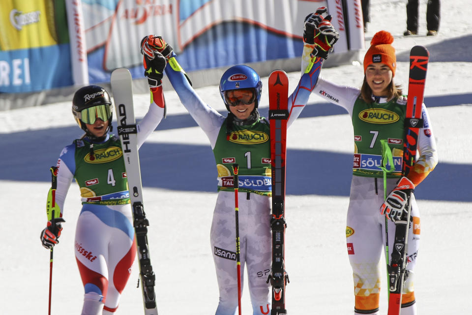 Winner United States' Mikaela Shiffrin, center, is celebrates with second places Switzerland's Lara Gut-Behrami, left and third placed Slovakia's Petra Vlhova on the podium after an alpine ski, women's World Cup giant slalom, in Soelden, Austria, Saturday, Oct. 23, 2021. (AP Photo/Marco Trovati)