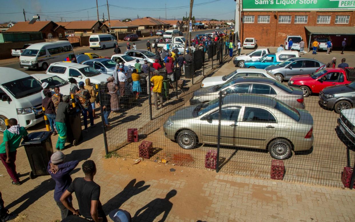 Customers queue to buy alcohol for the first time in two months in Johannesburg -  Themba Hadebe/AP