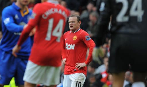 Manchester United's English forward Wayne Rooney (C) reacts at the final whistle after a 4-4 draw during the English Premier League football match between Manchester United and Everton at Old Trafford in Manchester