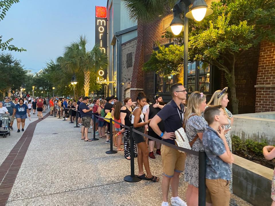 People wait to buy dessert from Gideon's Bakehouse in July 2022.