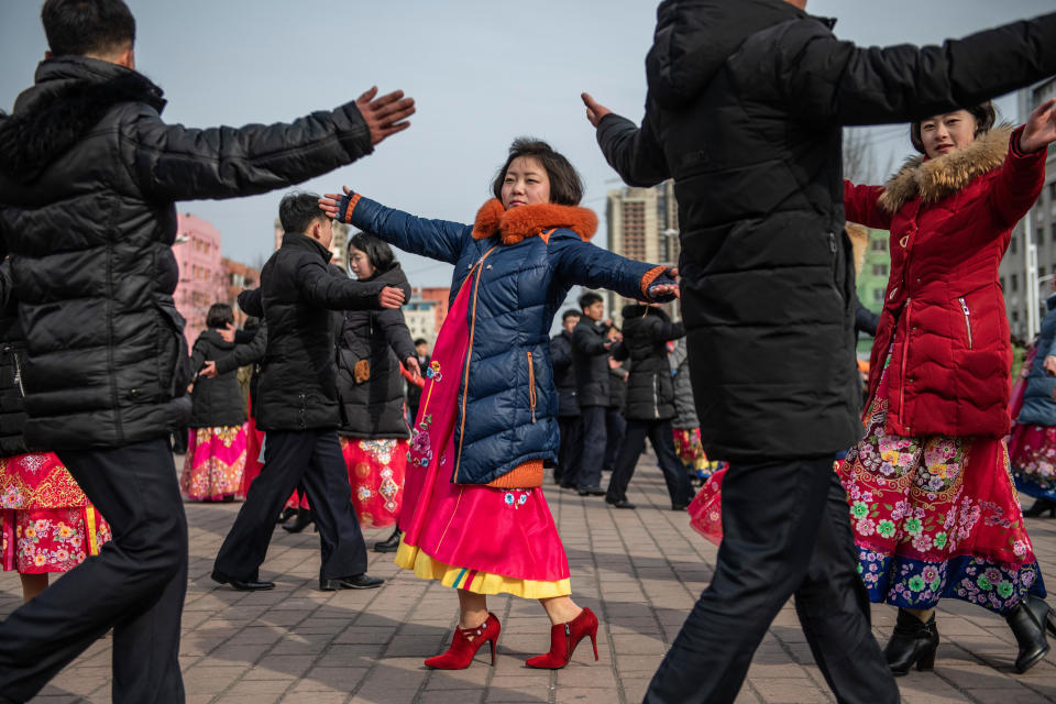 North Koreans, including women in traditional Korean hanbok dresses, take part in a mass dance to mark the 71st anniversary of the Korean Peoples Army on Feb. 8, in Pyongyang.