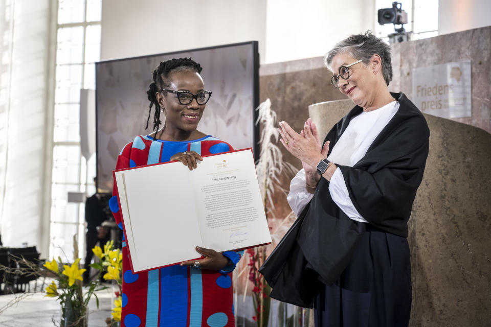 Author Tsitsi Dangarembga, from Zimbabwe, receives the Peace Prize of the German Book Trade from Karin Schmidt-Friderichs, president of the Börsenverein des Deutschen Buchhandels, in Frankfurt, Germany, Sunday, Oct. 24, 2021 (Thomas Lohnes/epd-Pool/dpa via AP)