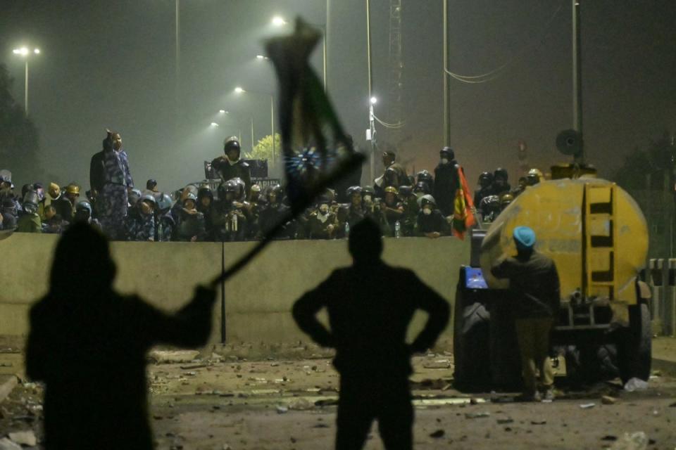 Paramilitary forces block a highway to prevent farmers from marching towards India’s capital during a protest demanding minimum crop prices, at Shambhu Haryana-Punjab border near Delhi (AFP via Getty Images)