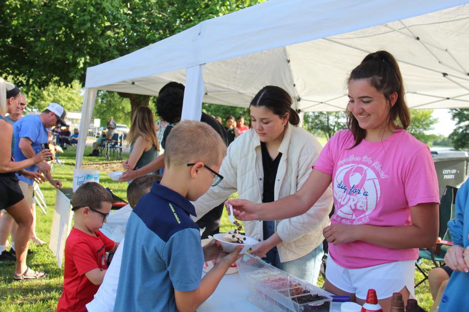 Members of the Perry Class of 2024 serve brownie sundaes during Friday Fest on June 3, 2022, at Pattee Park to raise funds for the 2023 prom.