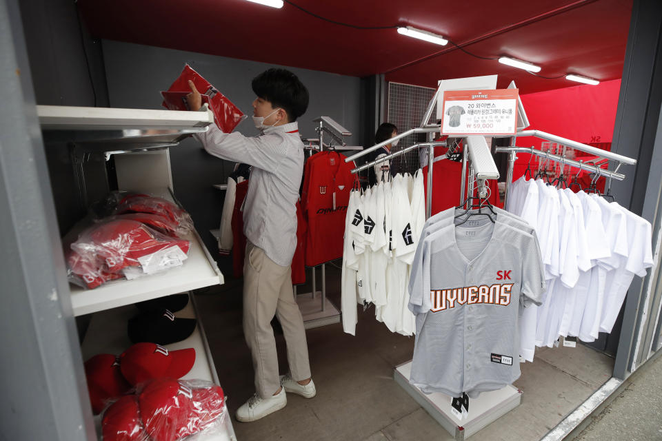 SK Wyverns' merchandise is displayed for sale before a start of baseball game between Hanwha Eagles and SK Wyverns in Incheon, South Korea, Tuesday, May 5, 2020. Cheerleaders danced beneath rows of empty seats and umpires wore protective masks as a new baseball season began in South Korea. After a weeks-long delay because of the coronavirus pandemic, a hushed atmosphere allowed for sounds like the ball hitting the catcher's mitt and bats smacking the ball for a single or double to echo around the stadium. (AP Photo/Lee Jin-man)