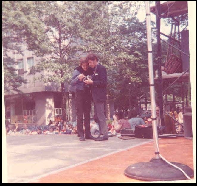 Ohio Ballet Artistic Director Heinz Poll, left, and lighting designer Tom Skelton consult at Cascade Plaza in Akron, site of the company's first free outdoor summer dance performance in 1974.