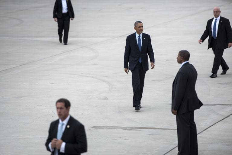 Members of the US Secret Service escort US President Barack Obama as he walks to Air Force One at Gary Chicago International Airport on October 2, 2014 in Gary, Indiana