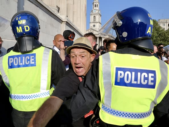 Members of StandUpX community who are anti-vaccine and are against the novel coronavirus (COVID-19) measures, gather at Trafalgar Square to stage for a protest, face off with police officers, in London.