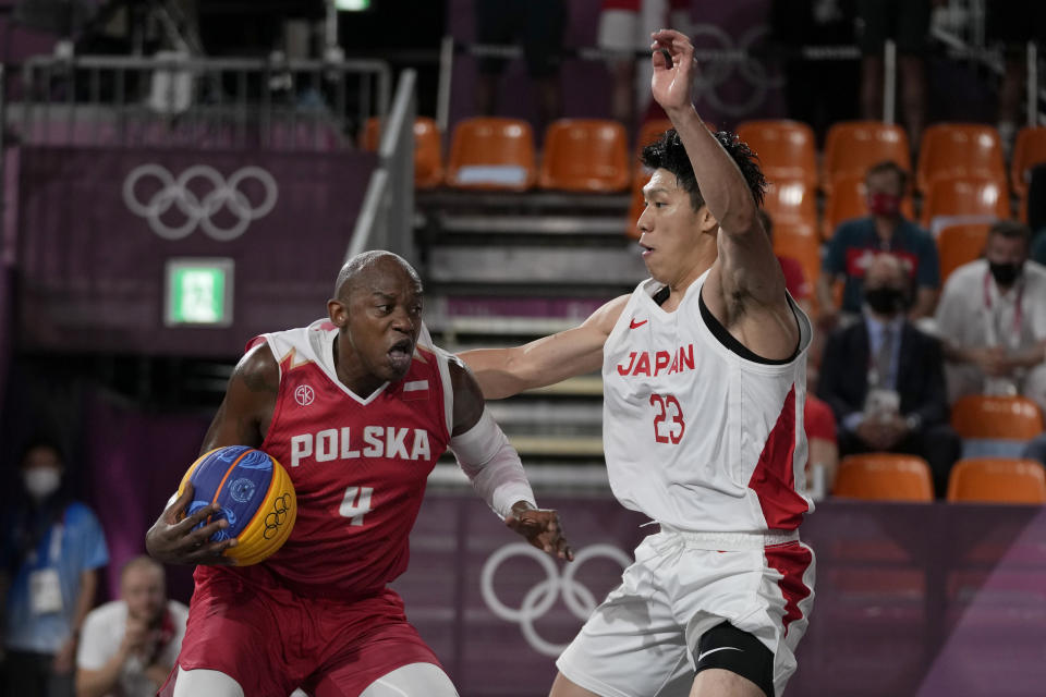 Poland's Michael Hicks (4) heads to the basket past Japan's Ryuto Yasuoka (23) during a men's 3-on-3 basketball game at the 2020 Summer Olympics, Saturday, July 24, 2021, in Tokyo, Japan. (AP Photo/Jeff Roberson)