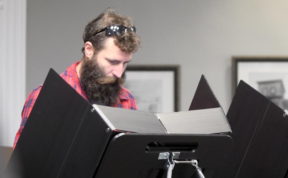 Justin Geiser of Massillon casts his ballot Tuesday at the Massillon Public Library.