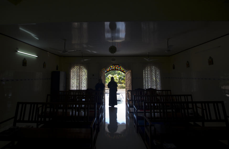 In this Sunday, Nov. 4, 2018, photo, a nun walks out of chapel of St. Francis Mission Home after offering prayers, in Kuravilangad in the southern Indian state of Kerala. For decades, nuns in India have quietly endured sexual pressure from Catholic priests, an AP investigation has revealed. (AP Photo/Manish Swarup)