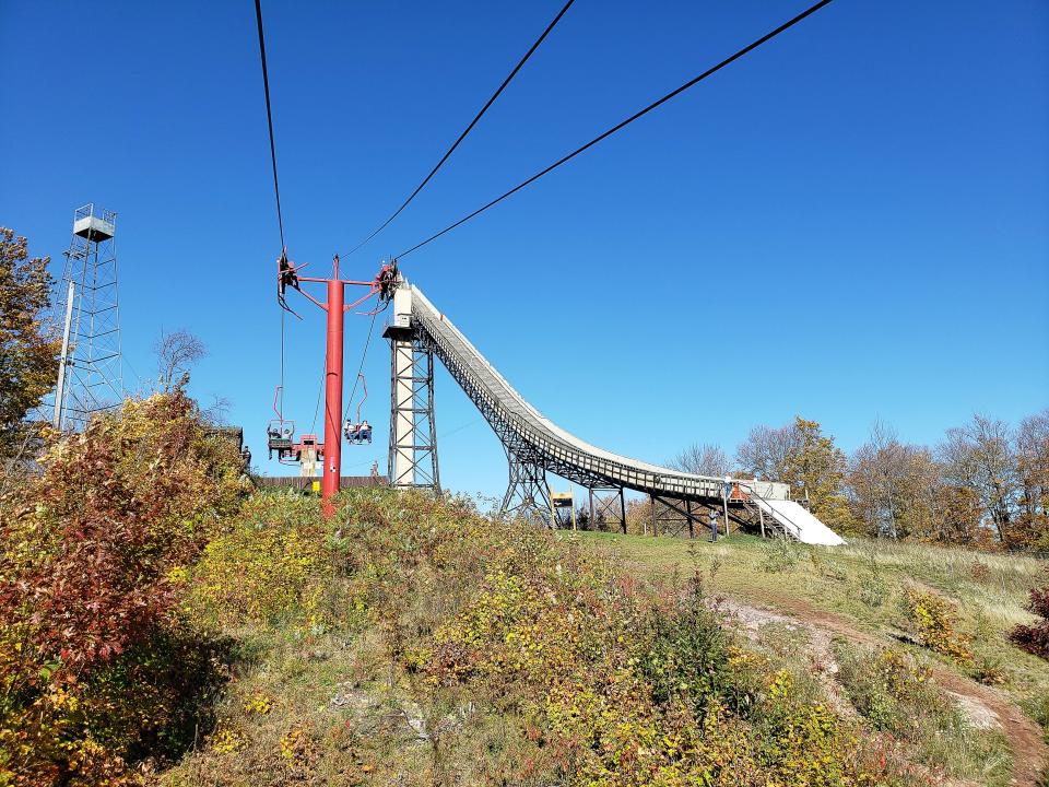 A chairlift takes sightseers to the base of the Copper Peak ski jump in Ironwood, Mich., October 7, 2021.