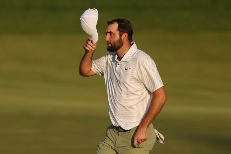 Top-ranked Scottie Scheffler, tipping his cap to fans at the end of his first round of the PGA Championship, was reportedly handcuffed and detained by police early Friday morning for trying to drive around police cars and enter Valhalla Golf Club (Christian Petersen)