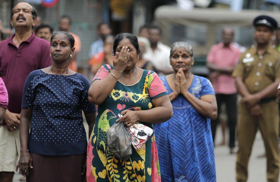 FILE - In this April 28, 2019, file photo, Sri Lankan Catholics pray standing on a road as they attend a brief holy service marking the seventh day of the Easter Sunday bomb attacks near St. Anthony's Church in Colombo, Sri Lanka. Worries about Islamic extremism will be paramount for many Sri Lankan voters while others hope to block former leaders accused of human rights violations from returning to power in Saturday’s presidential election, the country’s first national polls since last Easter’s deadly suicide attacks. Simply put, fear is driving the election in Sri Lanka, a South Asian island nation of 22 million people off India’s southern tip. (AP Photo/Eranga Jayawardena, File)