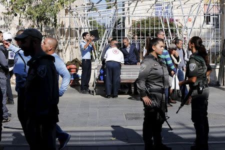 Israeli security personnel and medics stand at the area where a stabbing attack by two Palestinian women took place in central Jerusalem, November 23, 2015. REUTERS/Ammar Awad