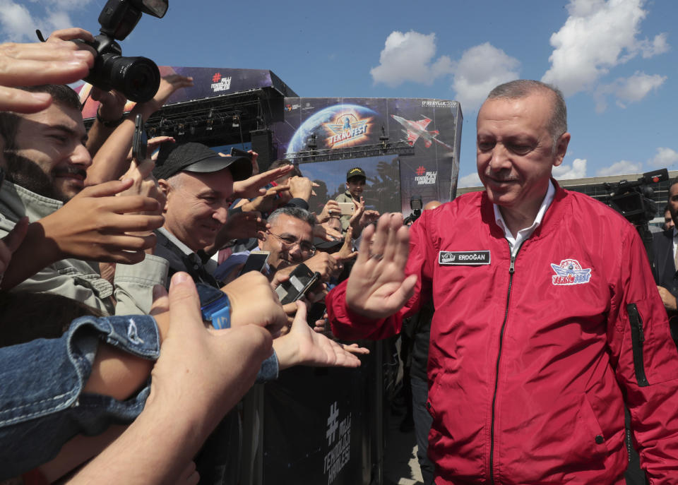 Turkey's President Recep Tayyip Erdogan with his supporters at a technology fair in Istanbul, Saturday, Sept. 21, 2019. Erdogan expressed frustration with what he said was the United States' continued support to Syrian Kurdish forces that Turkey regards as terrorists and reiterated that Turkey had completed all preparations for a possible unilateral military operation in northeast Syria, along the Turkish border east of the Euphrates River.(Presidential Press Service via AP, Pool)