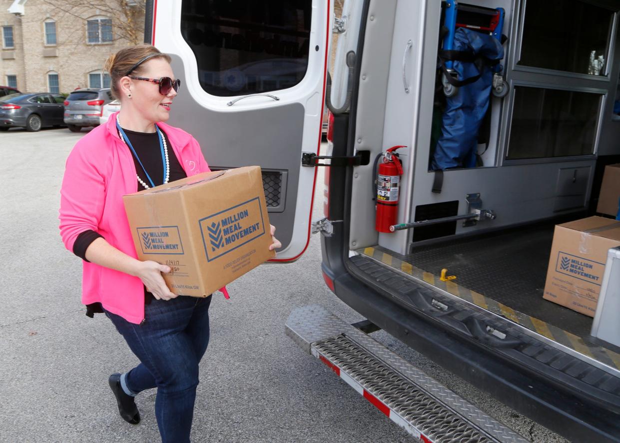 Andrea Tonsing-Carter brings a box of donated food items for the Fill the Ambulance Food Drive Thursday, November 8, 2018, at Elmcroft senior living community 3575 Senior Place in West Lafayette. Elmcroft teamed with Phoenix Paramedics Solutions for the food drive to benefit Food Finders Food Bank.