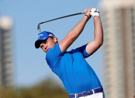 Danny Willett of England tees off on the 15th hole during the Dubai Desert Classic golf championship February 7, 2016. REUTERS/Ahmed Jadallah