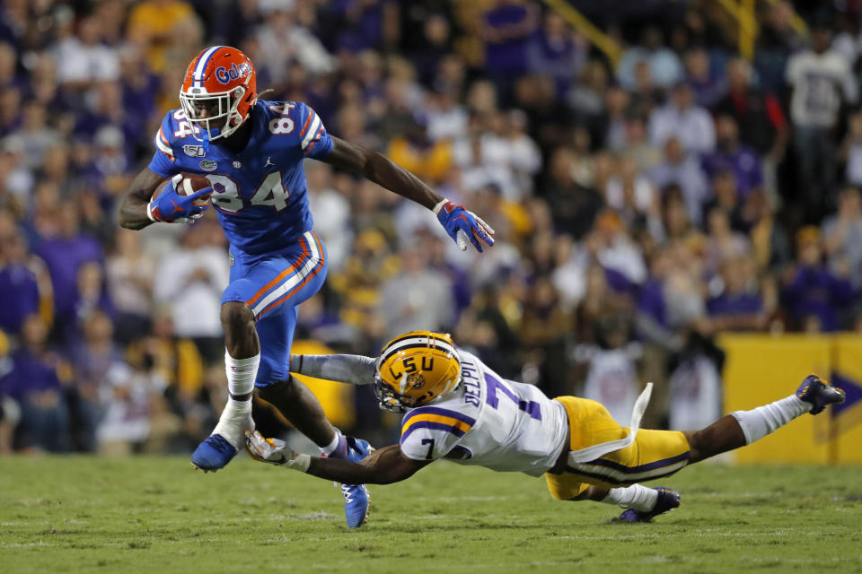 Florida tight end Kyle Pitts (84) carries against LSU safety Grant Delpit (7) in the first half of an NCAA college football game in Baton Rouge, La., Saturday, Oct. 12, 2019. (AP Photo/Gerald Herbert)