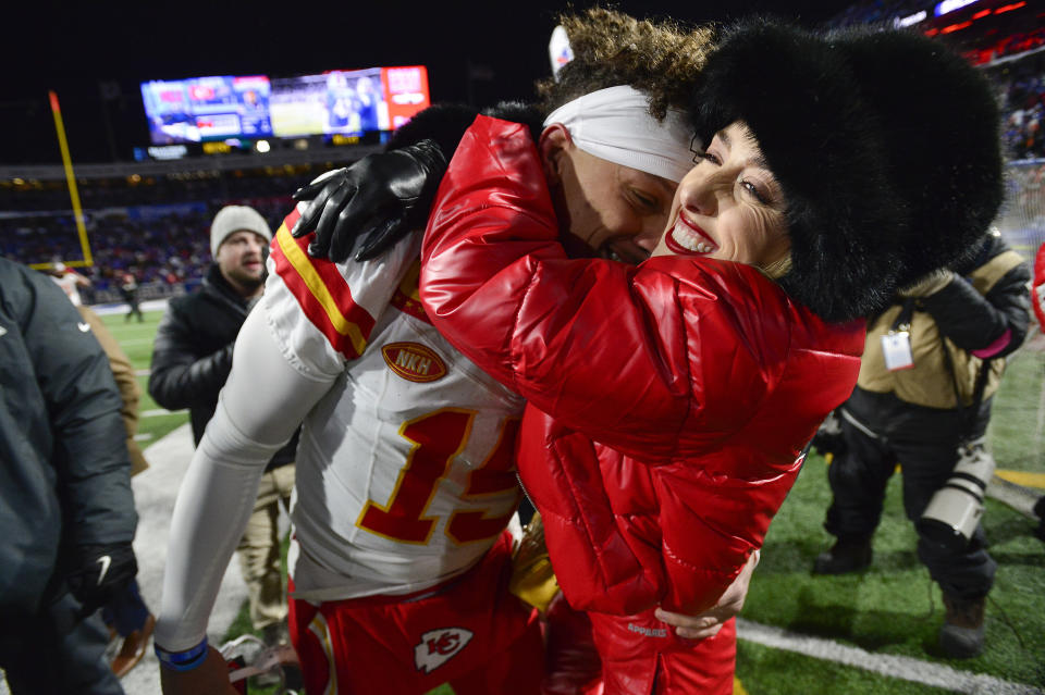 Brittany Mahomes, right, hugs Kansas City Chiefs quarterback Patrick Mahomes (15) before an NFL AFC division playoff football game against the Buffalo Bills, Sunday, Jan. 21, 2024, in Orchard Park, N.Y. (AP Photo/Adrian Kraus)