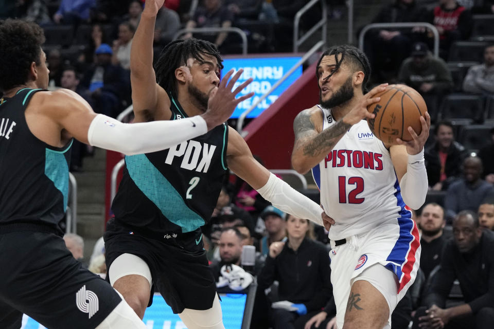 Detroit Pistons forward Isaiah Livers (12) looks to pass as Portland Trail Blazers forward Trendon Watford (2) defends during the second half of an NBA basketball game, Monday, March 6, 2023, in Detroit. (AP Photo/Carlos Osorio)