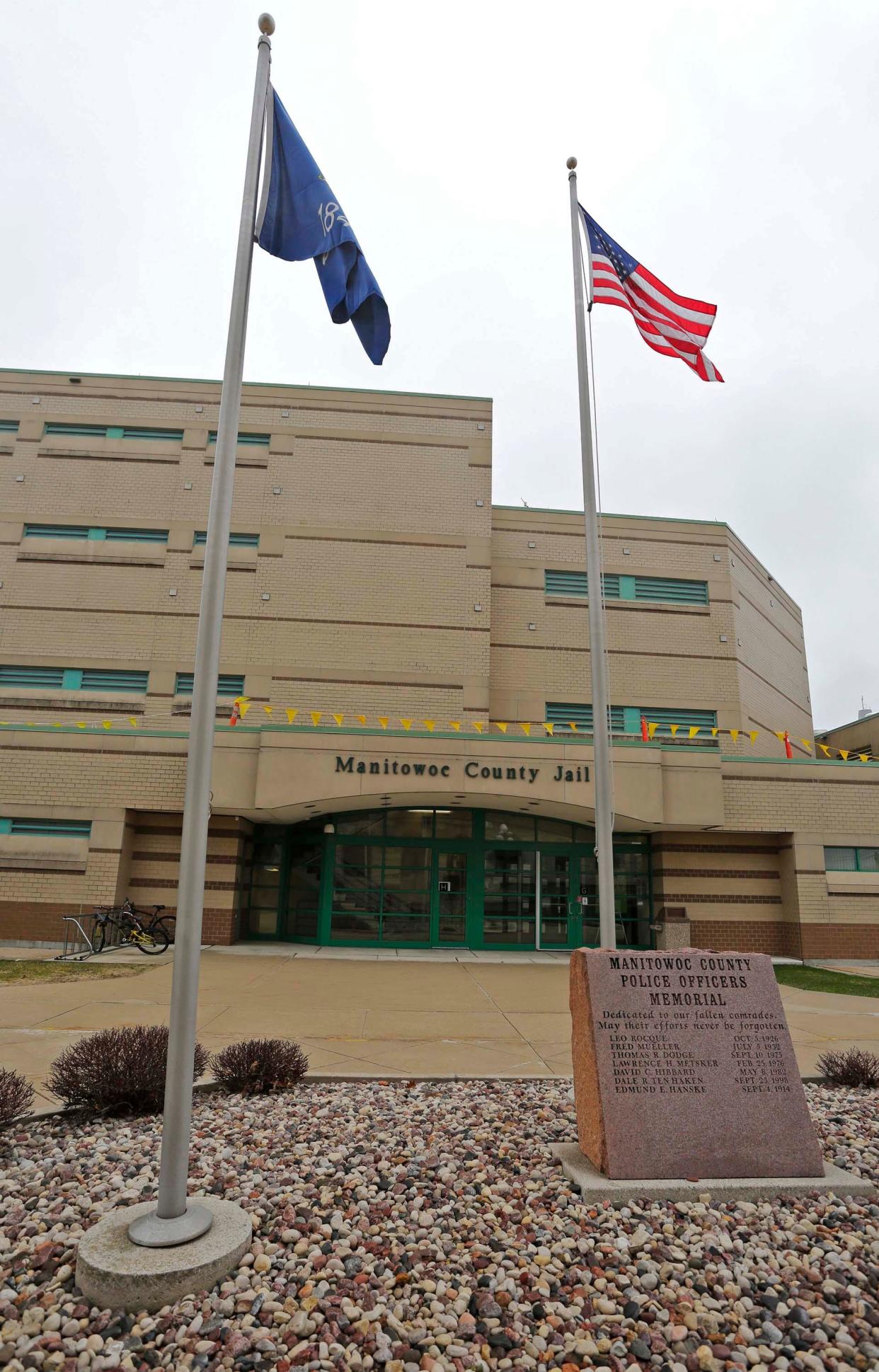 Flags flutter in the wind near the Manitowoc County Jail as seen, Thursday, April 23, 2020, in Manitowoc, Wis.
