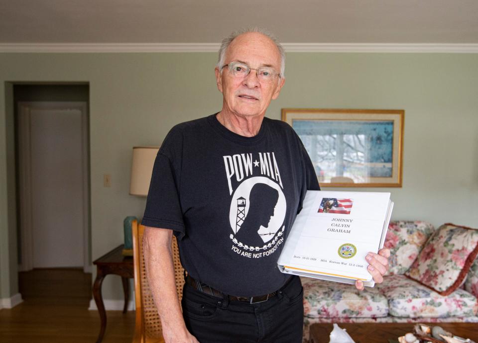George Graham poses Tuesday, Nov. 15, 2022, at his home in Rockford holding a binder filled with information about his uncle, Johnny Graham, who went missing in action in Korea in 1950.
