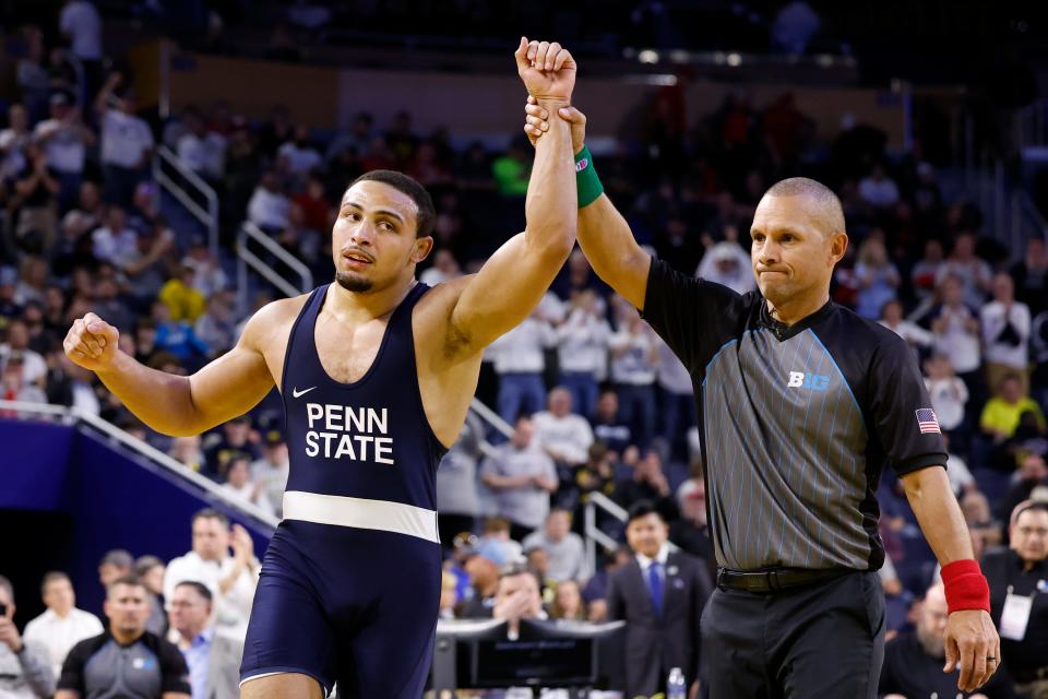 Penn State's Aaron Brooks has his arm raised in victory after defeating Ohio State's Kaleb Romero 12-2 for the 184-pound title at the Big Ten Wrestling Championships in Ann Arbor, Mich.