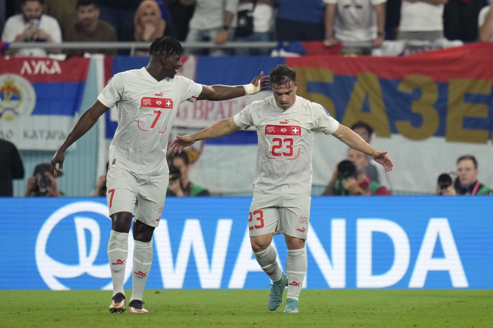 Switzerland's Xherdan Shaqiri, right, celebrates with teammate Breel Embolo after scoring his side's first goal during the World Cup group G soccer match between Serbia and Switzerland, in Doha, Qatar, Qatar, Friday Dec. 2, 2022. (AP Photo/Ricardo Mazalan)