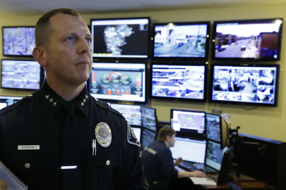 FILE - In this April 22, 2014, file photo, then Chief Scott Thomson watches one of the live video monitors in the command center of the Camden County Metro police in Camden, N.J. (AP Photo/Mel Evans, File)